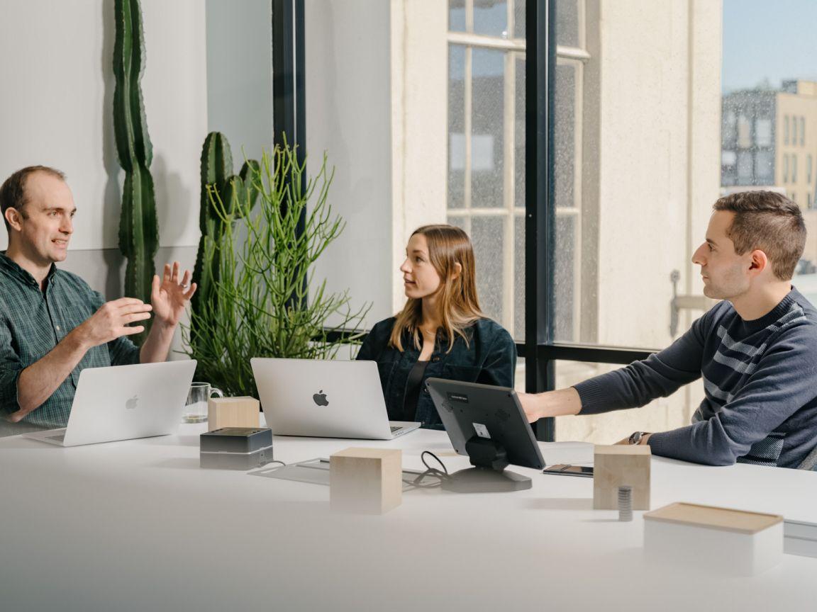 Team members collaborating in meeting room